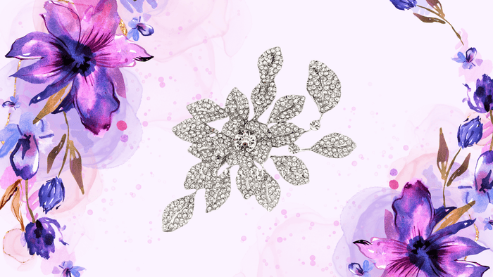 花と葉をかたどったクリスタルのブローチと紫の花のイラスト